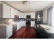 Well-lit kitchen with white cabinets, stainless steel appliances, and a dining area at 5411 Chandler Way, Denver, CO 80239