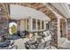 Relaxing covered porch with stone accents and comfortable seating at 7285 Sagebrush Dr, Parker, CO 80138