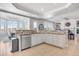 Modern kitchen with white cabinets, granite counters and island at 7285 Sagebrush Dr, Parker, CO 80138