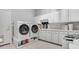 Bright laundry room with washer, dryer, and ample cabinets at 7285 Sagebrush Dr, Parker, CO 80138