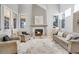 Spacious living room featuring a cozy fireplace and ample natural light at 7285 Sagebrush Dr, Parker, CO 80138