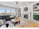 Bright living room with fireplace, built-in shelving, and large windows at 7285 Sagebrush Dr, Parker, CO 80138