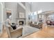 Bright and airy living room with hardwood floors and fireplace at 7285 Sagebrush Dr, Parker, CO 80138