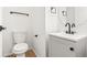 Modern half bathroom featuring a vanity sink, a toilet, and a mirror at 1129 W 112Th Ave # C, Denver, CO 80234