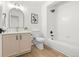 Bright bathroom features wood-look flooring, tub shower, and a vanity with tan cabinetry and black hardware at 1129 W 112Th Ave # C, Denver, CO 80234