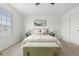 Cozy bedroom featuring carpeted floors, a ceiling fan, natural light from the window, and a light-colored bed at 1129 W 112Th Ave # C, Denver, CO 80234