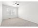 Empty bedroom featuring a window, carpeted floors, a ceiling fan, and neutral-colored walls at 1129 W 112Th Ave # C, Denver, CO 80234