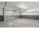 Clean garage with a roll-up metal door, shelving, and a light at 1129 W 112Th Ave # C, Denver, CO 80234