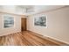 Bedroom featuring hardwood floors and windows at 1200 Newark St, Aurora, CO 80010