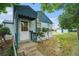 Side view of the home's front exterior, showing a fenced yard and quaint design at 1200 Newark St, Aurora, CO 80010