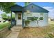 Charming front exterior with a cute covered porch and steps leading to the front door at 1200 Newark St, Aurora, CO 80010