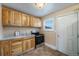 Functional kitchen features wood cabinets, stainless steel appliances, and a window at 1200 Newark St, Aurora, CO 80010