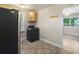 This kitchen features a modern washer/dryer combo and updated features at 1200 Newark St, Aurora, CO 80010