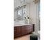 A stylish bathroom features a sleek vanity with dark wood cabinets and modern fixtures under a large mirror at 2800 E 2Nd Ave # 202, Denver, CO 80206