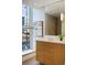 Bright bathroom with modern vanity, built-in storage and mirror at 2800 E 2Nd Ave # 202, Denver, CO 80206