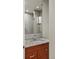 A modern bathroom features a granite countertop, wood cabinet, decorative mirror, and a glass-enclosed shower at 2800 E 2Nd Ave # 202, Denver, CO 80206