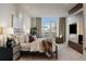 Bright bedroom with a large window and a decorative fireplace that adds an eye-catching design element to the space at 2800 E 2Nd Ave # 202, Denver, CO 80206