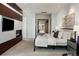 This spacious bedroom features a modern fireplace, TV, and large bed offering a cozy and stylish retreat at 2800 E 2Nd Ave # 202, Denver, CO 80206