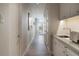Hallway with tiled floor leading to a bright window; features modern lighting and a convenient wet bar at 2800 E 2Nd Ave # 202, Denver, CO 80206