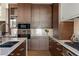 Close up on kitchen with stainless steel appliances, wood cabinets, and white countertop at 2800 E 2Nd Ave # 202, Denver, CO 80206