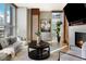 Bright living room with hardwood floors, fireplace, and city views from large windows at 2800 E 2Nd Ave # 202, Denver, CO 80206