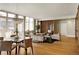 A spacious living room boasts abundant natural light, hardwood floors, designer lighting and an open floor plan at 2800 E 2Nd Ave # 202, Denver, CO 80206
