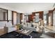Bright living room with modern furniture, wood accents, and open floor plan at 2800 E 2Nd Ave # 202, Denver, CO 80206