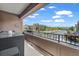 Outdoor balcony includes seating and views of nearby buildings, trees, and landscape at 1000 Elmhurst Dr # B, Highlands Ranch, CO 80129