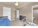 Comfortable bedroom featuring a work desk, chair and adjacent bathroom at 1000 Elmhurst Dr # B, Highlands Ranch, CO 80129