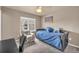 Cozy bedroom with a daybed, chair, and a window offering natural light at 1000 Elmhurst Dr # B, Highlands Ranch, CO 80129