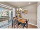 Bright dining area with natural light, table set for four, and sliding doors to the outside at 1000 Elmhurst Dr # B, Highlands Ranch, CO 80129