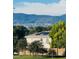 Inviting home featuring solar panels, a well-maintained lawn, and stunning mountain views at 1000 Elmhurst Dr # B, Highlands Ranch, CO 80129