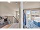 Hallway leads to a bedroom with a door to the balcony and an additional staircase at 1000 Elmhurst Dr # B, Highlands Ranch, CO 80129