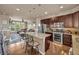 Open kitchen flows into living room with island, stainless appliances, and lots of cabinet space at 1000 Elmhurst Dr # B, Highlands Ranch, CO 80129