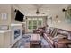 Inviting living room with a fireplace, large windows, and a comfortable leather sofa at 1000 Elmhurst Dr # B, Highlands Ranch, CO 80129