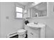 Bright bathroom with white beadboard walls, a classic vanity, and natural light at 7076 S Spruce W Dr, Centennial, CO 80112