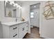 Modern bathroom with white cabinets, quartz countertops and a decorative mirror at 7076 S Spruce W Dr, Centennial, CO 80112