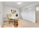 Neutral bedroom with a desk, decorative vases, and a closet with sliding doors at 7076 S Spruce W Dr, Centennial, CO 80112