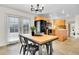 Bright dining room adjacent to kitchen area featuring a wooden table and backyard view at 7076 S Spruce W Dr, Centennial, CO 80112