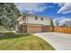 A two-story house featuring a brick facade and a spacious driveway, blending style and functionality at 7076 S Spruce W Dr, Centennial, CO 80112