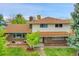 Charming two-story home featuring brick and siding exterior with a well-manicured lawn at 7076 S Spruce W Dr, Centennial, CO 80112