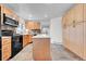 Bright kitchen featuring an island, wooden cabinets, and modern appliances at 7076 S Spruce W Dr, Centennial, CO 80112