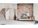 Cozy living room showcasing a brick fireplace, decorative vase, and adjacent stairway at 7076 S Spruce W Dr, Centennial, CO 80112