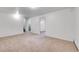 Spacious carpeted living room with several doorways and a staircase to another floor at 7076 S Spruce W Dr, Centennial, CO 80112