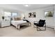 Bright main bedroom with minimalist decor, multiple windows, and carpeted floors at 7076 S Spruce W Dr, Centennial, CO 80112