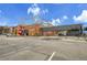 Commercial building featuring the Pindustry with parking, Beer Garden, and mural art at 7076 S Spruce W Dr, Centennial, CO 80112