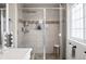Modern bathroom with a glass-enclosed shower and decorative tile accents at 13228 E Asbury Dr, Aurora, CO 80014