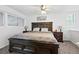 Cozy bedroom with a large wooden bed frame, side tables, and a neutral color palette at 13228 E Asbury Dr, Aurora, CO 80014