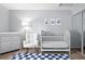 Serene Bedroom with a crib, changing table, and soft, plush rocking chair at 13228 E Asbury Dr, Aurora, CO 80014