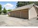 Three single-car garages on a paved parking lot at 13228 E Asbury Dr, Aurora, CO 80014